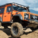 Land Rover's off-road vehicle demonstrating its 4x4 capabilities with the long suspension travel and crossover axles in Georgia.