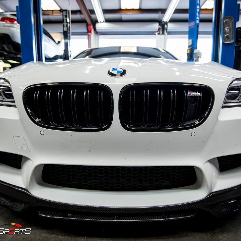 Bmw f10 m5 in for front lip spoiler install. Carbon fibre lip spoiler installed on bmw m5 f10.