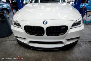 Bmw f10 m5 in for front lip spoiler install. Carbon fibre lip spoiler installed on bmw m5 f10.