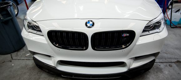 Bmw f10 m5 in for front lip spoiler install. Carbon fibre lip spoiler installed on bmw m5 f10.